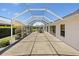 Spacious enclosed patio with an outdoor dining set, seamlessly extending the living space at 3008 Bridgefield Ct, The Villages, FL 32162