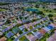 Scenic aerial view overlooking a residential neighborhood near a golf course and a tranquil lake at 3112 Burbank Ln, The Villages, FL 32162