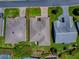 An aerial view displaying the house, driveway, lawn, and surrounding homes at 3112 Burbank Ln, The Villages, FL 32162