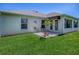 Lovely view of a well maintained backyard with a patio and lawn at 3112 Burbank Ln, The Villages, FL 32162