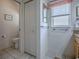 Bathroom features tile floor, granite counter, window and access to toilet area at 3112 Burbank Ln, The Villages, FL 32162