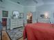Bedroom showcases a comfortable bed, hardwood floors, and doorway to dining area at 3112 Burbank Ln, The Villages, FL 32162