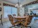Charming dining area with floral upholstered chairs, chandelier, and views into the living room at 3112 Burbank Ln, The Villages, FL 32162