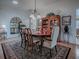 Formal dining room with hardwood floors, hutch, and chandelier at 3112 Burbank Ln, The Villages, FL 32162