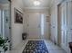 Bright foyer with tile flooring, decorative rug, and crown molding at 3112 Burbank Ln, The Villages, FL 32162