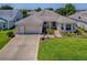 Charming single-story home with a well-manicured lawn and a two-car garage at 3112 Burbank Ln, The Villages, FL 32162