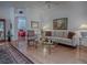 Bright living room with hardwood floors and neutral decor, open to other rooms at 3112 Burbank Ln, The Villages, FL 32162