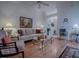 Cozy living room with hardwood floors, ceiling fan, and comfortable seating at 3112 Burbank Ln, The Villages, FL 32162