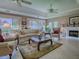Inviting living room with fireplace, plush seating, and neutral tones at 3112 Burbank Ln, The Villages, FL 32162