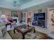 Inviting living room with fireplace, plush seating, neutral tones, and French doors at 3112 Burbank Ln, The Villages, FL 32162