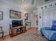Living room showcases a TV, wood console, comfortable blue chairs, and decorative accents at 3112 Burbank Ln, The Villages, FL 32162