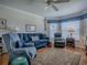 Inviting living room with a blue sofa set, recliner, area rug and lots of natural light at 3112 Burbank Ln, The Villages, FL 32162