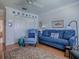 Cozy living room with blue furniture, an area rug, and decorative wall art at 3112 Burbank Ln, The Villages, FL 32162