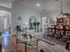Open-concept living space with hardwood floors, dining area, and ample natural light at 3112 Burbank Ln, The Villages, FL 32162