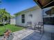 Outdoor patio area with decorative seating and a well maintained garden at 3112 Burbank Ln, The Villages, FL 32162