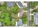 Well-maintained home in a tranquil neighborhood, boasting a spacious backyard with inviting fire pit and lush surroundings at 315 W 11Th Ave, Mount Dora, FL 32757