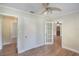 Bedroom featuring hard wood floors, neutral colored walls, and an attached room at 315 W 11Th Ave, Mount Dora, FL 32757
