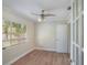 Bedroom with a ceiling fan, wood-look flooring, neutral walls, and lots of natural light at 315 W 11Th Ave, Mount Dora, FL 32757