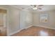 This bedroom features wood-look floors, neutral walls, and a ceiling fan at 315 W 11Th Ave, Mount Dora, FL 32757