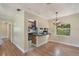 Open concept kitchen and dining area featuring wood floors, bar seating, and natural light at 315 W 11Th Ave, Mount Dora, FL 32757