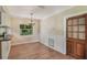 Bright dining area features wood floors, a chandelier, wainscoting, and views of the outdoor foliage at 315 W 11Th Ave, Mount Dora, FL 32757