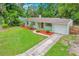 Charming single-story home boasts fresh landscaping, a driveway, and an attached garage at 315 W 11Th Ave, Mount Dora, FL 32757