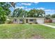 Charming single-story home with a well-manicured lawn and light blue shutters at 315 W 11Th Ave, Mount Dora, FL 32757