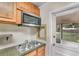 Well-lit kitchen with stainless steel appliances, granite counters, and convenient backyard access at 315 W 11Th Ave, Mount Dora, FL 32757