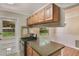 Well-equipped kitchen with stainless steel appliances, granite counters, and pass-through window to the dining area at 315 W 11Th Ave, Mount Dora, FL 32757