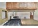 Close up of kitchen featuring stainless steel oven, cooktop, overhead wood cabinets, and granite countertops at 315 W 11Th Ave, Mount Dora, FL 32757