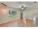 Living room with wood-look floors, ceiling fan, pendant lights, and natural light at 315 W 11Th Ave, Mount Dora, FL 32757