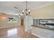 Bright living room with wood floors, stylish light fixtures, and an open floor plan at 315 W 11Th Ave, Mount Dora, FL 32757