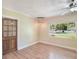 Living room featuring wood-look floors, modern lighting fixture, and window view at 315 W 11Th Ave, Mount Dora, FL 32757