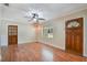 Open-concept living room with hardwood floors, ceiling fan, and natural light at 315 W 11Th Ave, Mount Dora, FL 32757