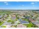 Scenic aerial view of a residential community featuring well-manicured lawns and streets and multiple lakes nearby at 3405 Nursery Pl, The Villages, FL 32163