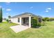 A well maintained backyard shows a patio, plantings, and grass at 3405 Nursery Pl, The Villages, FL 32163