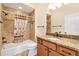 Charming bathroom features warm brown tile, shower over tub, and granite countertop at 3405 Nursery Pl, The Villages, FL 32163