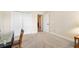 Bright bedroom featuring neutral carpeting, closet, and adjacent doorway at 3405 Nursery Pl, The Villages, FL 32163