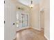 Welcoming foyer featuring tile flooring, decorative front door with sidelights, and neutral wall color at 3405 Nursery Pl, The Villages, FL 32163
