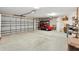 Spacious garage featuring a two-car door, sink, and golf cart at 3405 Nursery Pl, The Villages, FL 32163