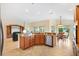 Bright kitchen with granite countertops, stainless steel appliances, and a view of the living area at 3405 Nursery Pl, The Villages, FL 32163