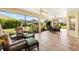 Relaxing screened lanai with wicker furniture, tile flooring, and ceiling fans at 3405 Nursery Pl, The Villages, FL 32163