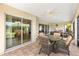 Inviting screened lanai with tile flooring, furniture, and backyard view at 3405 Nursery Pl, The Villages, FL 32163