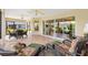 Inviting screened lanai with tile floors, furniture, and beautiful views of the backyard at 3405 Nursery Pl, The Villages, FL 32163