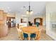Open-concept home features kitchen, dining area and living area with tile and wood floors at 3405 Nursery Pl, The Villages, FL 32163