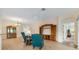 Open living room with wood flooring, ceiling fan, and traditional furniture showcasing ample natural light at 3405 Nursery Pl, The Villages, FL 32163