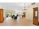 Bright living room showcasing wood flooring, ceiling fan, and sliding glass doors to the lanai at 3405 Nursery Pl, The Villages, FL 32163