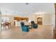 Open living room with wood flooring, ceiling fan, and views of the kitchen and dining area at 3405 Nursery Pl, The Villages, FL 32163