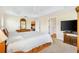 Cozy main bedroom features a trey ceiling, carpet, and a doorway to the kitchen at 3405 Nursery Pl, The Villages, FL 32163