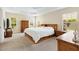 Bright main bedroom with a ceiling fan, carpet floors, and many windows at 3405 Nursery Pl, The Villages, FL 32163
